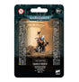 Front of a dark teal and black hanging package featuring a painted T’au miniature in orange-brown armor with a pale blue head, standing on rocky ground with a long weapon. The card reads “WARHAMMER 40,000,” “T’AU EMPIRE” and “DARKSTRIDER.”