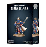 Black Space Marines: Primaris Captain miniature box showing a blue-armored figure with gold trim, a raised sword, rifle, red details and a flowing white cloak; a second view appears on the side panel. The front reads “PRIMARIS CAPTAIN” and “1 CITADEL MINIATURE.”