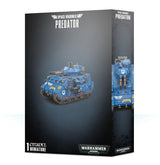 A dark gray box for a Space Marines Predator miniature shows a blue tracked tank with a turret and mounted guns on the front, plus a close front view on the side panel. The box reads “SPACE MARINES” and “PREDATOR.”