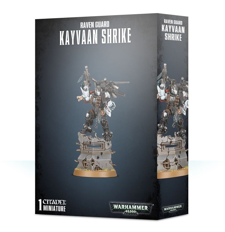 Dark gray Games Workshop box showing a black-armored miniature with white accents, raised weapon and a sculpted stone base on the front and side panels. The front reads “RAVEN GUARD KAYVAAN SHRIKE” and “WARHAMMER 40,000.”