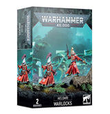 Box for Aeldari Warlocks miniatures, showing two figures in ornate red robes with pale helmets and long weapons against a blue-green landscape. The front reads “WARHAMMER 40,000,” “AELDARI WARLOCKS” and “2 MINIATURES”; the side repeats the artwork.