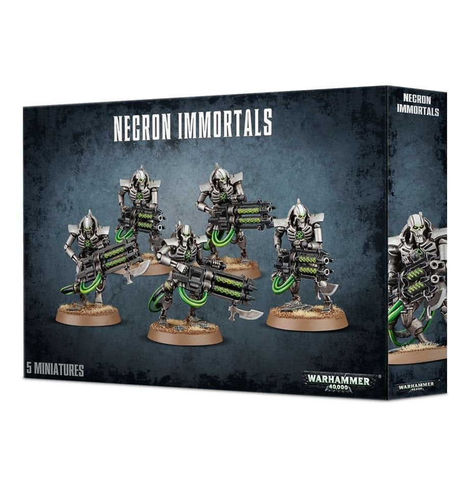 Dark blue-black Necron Immortals miniature box shown from the front and right side, featuring five silver skeletal sci-fi figures with green accents and weapons. The front reads “NECRON IMMORTALS” and “5 MINIATURES.”