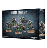 Dark blue-black Necron Immortals miniature box shown from the front and right side, featuring five silver skeletal sci-fi figures with green accents and weapons. The front reads “NECRON IMMORTALS” and “5 MINIATURES.”