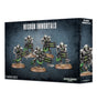 Dark blue-black Necron Immortals miniature box shown from the front and right side, featuring five silver skeletal sci-fi figures with green accents and weapons. The front reads “NECRON IMMORTALS” and “5 MINIATURES.”