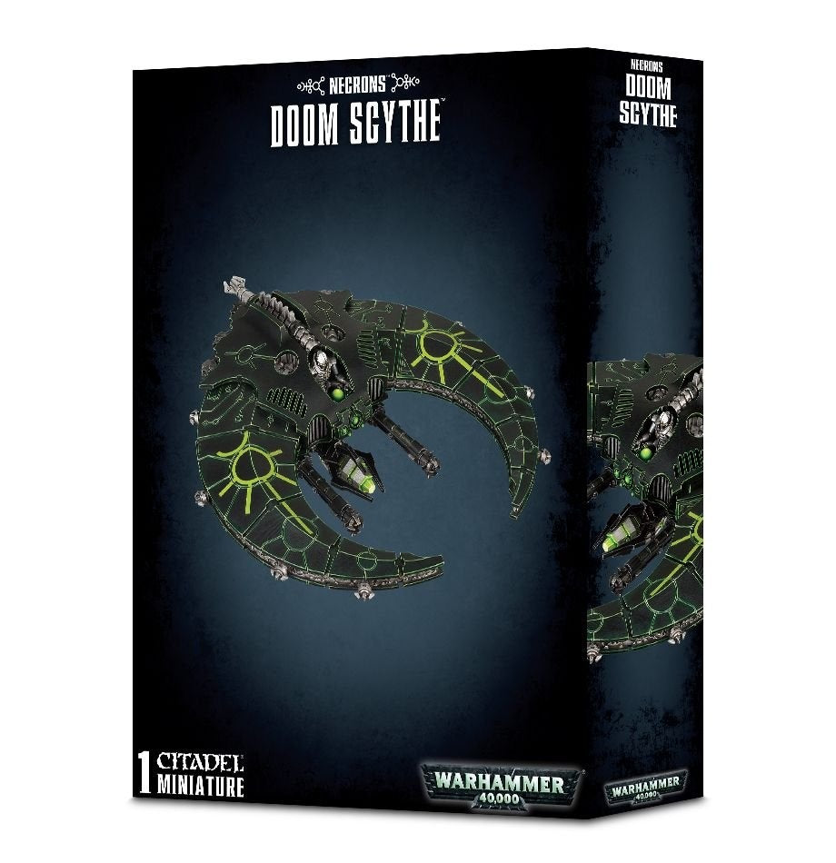 Black Games Workshop box showing a dark gray, crescent-shaped Necron spacecraft miniature with bright green geometric markings and silver details. The box reads “NECRONS” and “DOOM SCYTHE,” with a second partial view of the craft on its side.