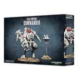 Box front and right side for a Tau Empire Commander miniature set, showing a white armored battlesuit with red accents beside a small hovering drone on a stand. The box reads “TAU EMPIRE COMMANDER” and “2 MINIATURES.”