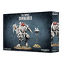 Box front and right side for a Tau Empire Commander miniature set, showing a white armored battlesuit with red accents beside a small hovering drone on a stand. The box reads “TAU EMPIRE COMMANDER” and “2 MINIATURES.”