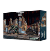 Boxed Warhammer 40,000: Sector Imperialis Ruins terrain set, with artwork of tall, weathered gothic wall sections and several armored miniatures on a ruined battlefield. The box reads “SECTOR IMPERIALIS RUINS” and “WARHAMMER 40,000.”