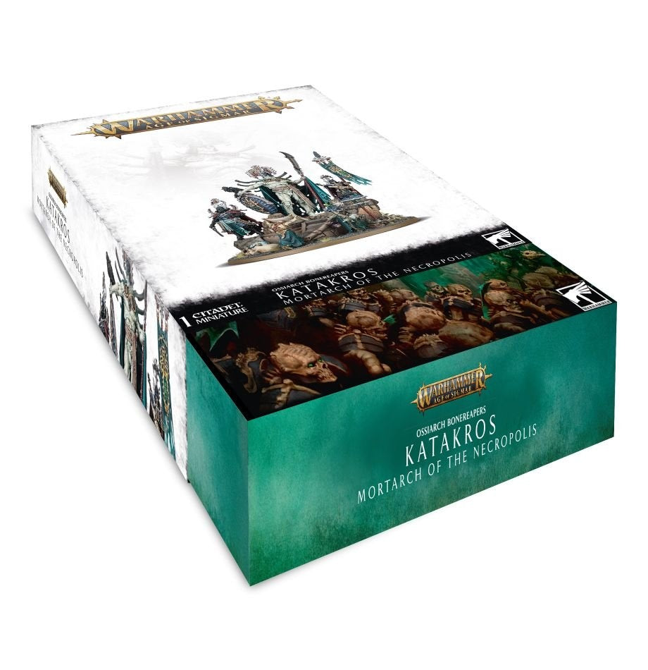 A rectangular Games Workshop miniature box shown from above at an angle, with a white lid depicting an ornate skeletal character and teal front panel. The packaging reads “KATAKROS MORTARCH OF THE NECROPOLIS” and “WARHAMMER AGE OF SIGMAR.”