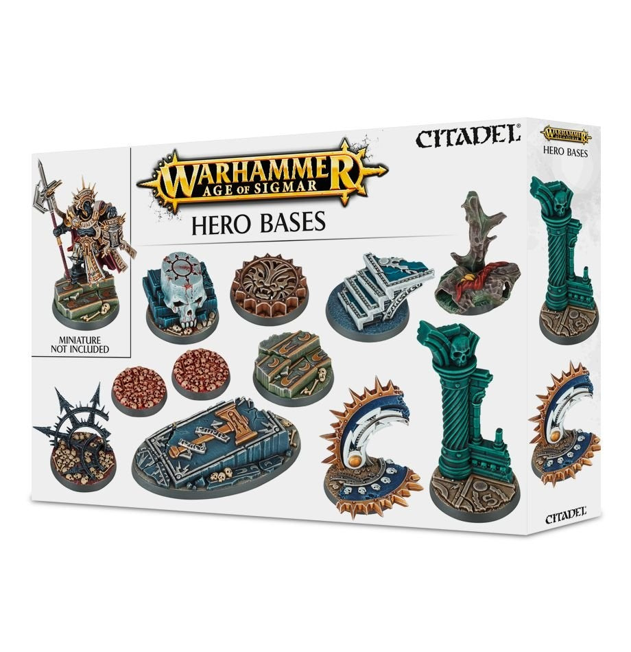 White Games Workshop box for miniature bases, shown from the front at an angle, with illustrations of ornate round and rectangular bases in teal, blue, bronze and brown, decorated with skulls and ruins. The package reads “WARHAMMER AGE OF SIGMAR,” “HERO BASES” and “MINIATURE NOT INCLUDED.”