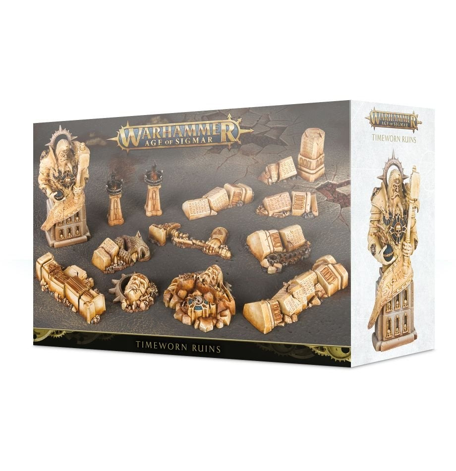 A Games Workshop “Warhammer Age of Sigmar” “Timeworn Ruins” box on a white background. The dark front panel displays tan, weathered-looking ruin terrain pieces, while the pale side panel shows a tall carved statue and the product title.