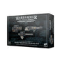 A dark charcoal box with blue technical-grid graphics shows three sci-fi weapons on the front and a narrow side panel with weapon artwork. The box reads “WARHAMMER THE HORUS HERESY” and “HEAVY WEAPONS UPGRADE SET.”