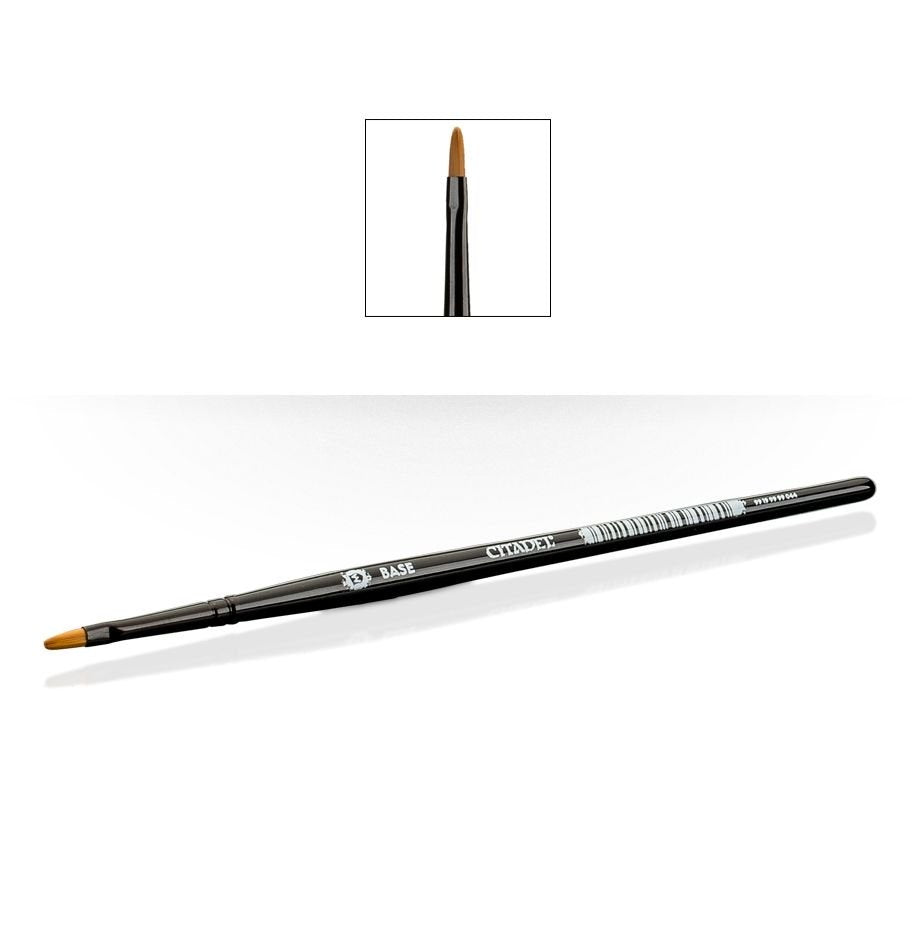 A black-handled brush lies diagonally, with short pointed brown bristles and white “CITADEL” and “BASE” lettering on the handle. An inset above shows a close-up of the tapered brush tip.