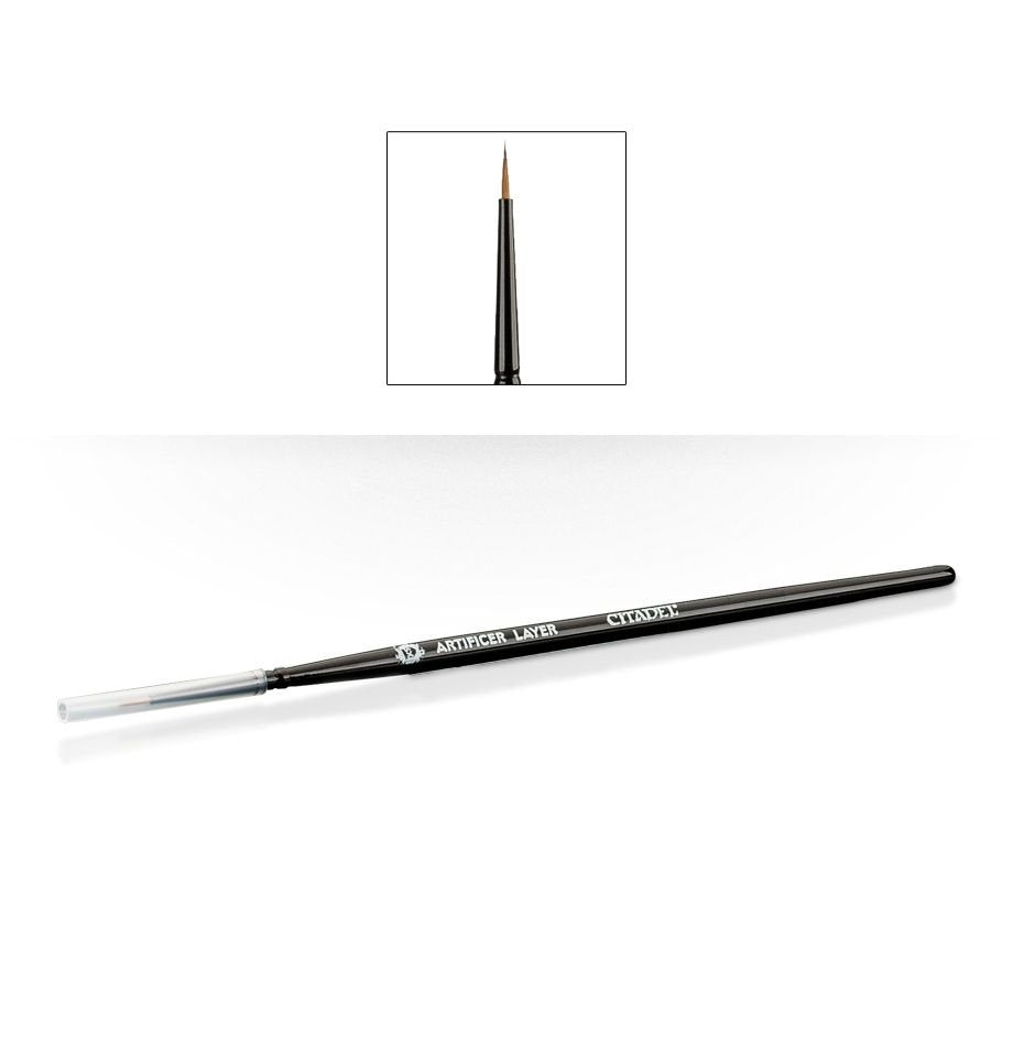 A slim black Citadel paintbrush lies diagonally with a clear cap over one end and fine brown pointed bristles; white lettering reads “ARTIFICER LAYER” and “CITADEL.” An inset above shows the pointed tip upright.