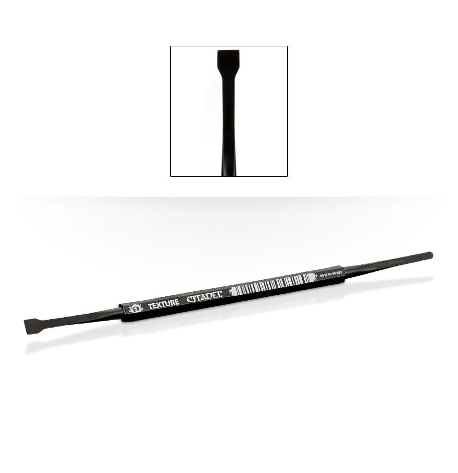 A long, slim black texture spreader tool lies diagonally on a white background, with a flat paddle tip at one end and a narrow rounded end at the other. An inset shows the paddle tip close up; white lettering on the handle reads “TEXTURE CITADEL.”