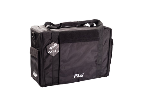 Black rectangular FLG Airborne carrying bag shown from the front and left side, with two top handles, a wide front pocket, side pocket and shoulder strap. White “FLG” logos appear on the front and side, and an FLG-branded tag hangs near the side.