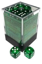 A clear cube-shaped box with a dark base holds translucent green six-sided dice with white pips; two matching dice sit in front. Green printed labels with small, unreadable lettering appear on the box sides.