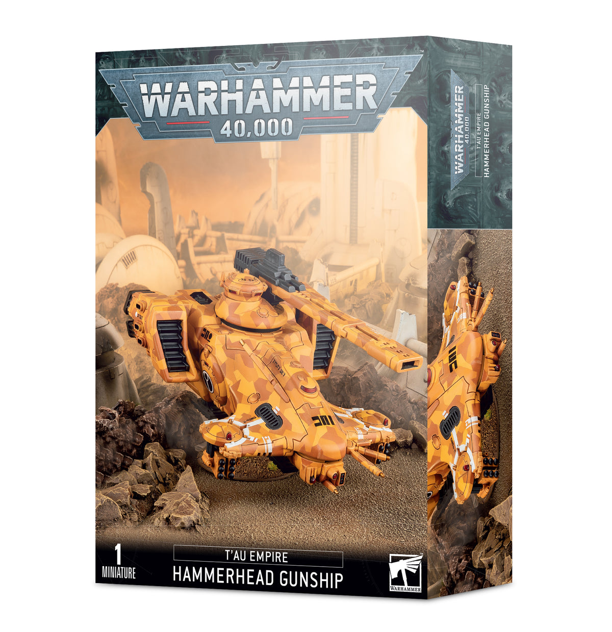 Box for a T’au Empire Hammerhead Gunship miniature, showing an orange-and-tan armored aircraft with long weapon barrels against a rocky battlefield; a narrow side panel shows another view. The box reads “WARHAMMER 40,000” and “T’AU EMPIRE HAMMERHEAD GUNSHIP.”