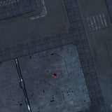 Close-up of the FLG Mats: Sector 17 gaming mat’s dark gray sci-fi terrain design, with large angular metal-like floor panels, fine black grid sections, etched lines and a few small red lights.