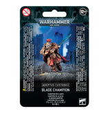 Front of a Warhammer 40,000 blister-card package showing a gold-armored Blade Champion with a red cape and raised blue-green sword against a blue battlefield scene. The card reads “ADEPTUS CUSTODES” and “BLADE CHAMPION,” with a 12+ age mark.