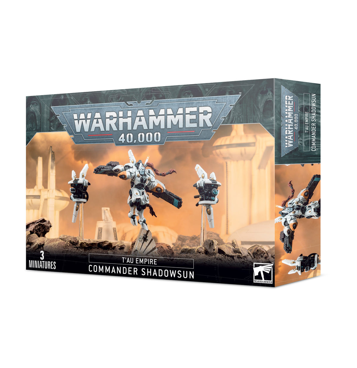 Warhammer 40,000 Commander Shadowsun miniature set box, shown from the front and right side. The box artwork shows a white-armored figure with dark weapons between two hovering drones against an orange sci-fi scene; front text reads “WARHAMMER 40,000,” “T’AU EMPIRE,” and “COMMANDER SHADOWSUN.”