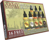 Boxed Army Painter metallic paint set, shown at an angle with eight small dropper bottles in gold, silver, bronze, copper and dark metal shades. The beige-green box has a red border and reads “THE ARMY PAINTER” and “METALLICS PAINT SET”; a badge says “16 FREE.”