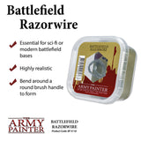 Clear plastic case containing a coil of gray razor wire, with a red, olive, and cream label reading “BATTLEFIELD RAZORWIRE” and “THE ARMY PAINTER.” The white product graphic also lists three uses and shaping tips beside red check marks.