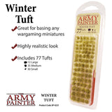 Clear blister pack of olive-green and tan Winter Tuft grass clumps, arranged in rows, with a pale yellow label reading “THE ARMY PAINTER” and “WINTER TUFT.” The accompanying graphic says “Includes 77 Tufts” in three sizes.