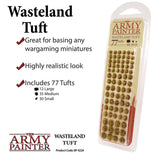 The Army Painter Wasteland Tuft pack in a clear blister contains rows of small, fuzzy olive-brown tufts in three sizes. The white product graphic reads “Wasteland Tuft” and “Includes 77 Tufts,” with “THE ARMY PAINTER” logo below.
