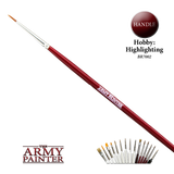 A fine hobby brush lies diagonally on a black background, with a pointed tan tip, silver ferrule and long red handle printed “ARMY PAINTER.” A small lineup of brushes appears at lower right, beside a circular “HANDLE” label; “THE ARMY PAINTER” logo is at lower left.