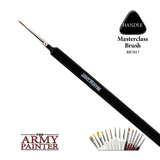 A fine pointed brush runs diagonally across a black background, with a shiny metal ferrule and long black handle marked “ARMY PAINTER.” A “HANDLE” callout and small lineup of brushes appear alongside the “THE ARMY PAINTER” logo.