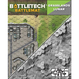 BattleTech battlemat shown with a diagonal split between green grassland terrain and grayscale lunar terrain, both printed with hex grids and structures. The header reads “BATTLETECH BATTLEMAT” and “GRASSLANDS LUNAR.”