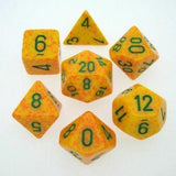 Seven yellow-orange speckled polyhedral dice are arranged on a white background, each marked with dark green numerals. The set includes several different shapes, with numbers such as 4, 6, 8, 12 and 20 visible.