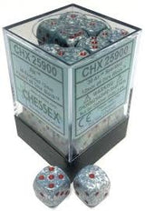 A clear square display box with a dark base holds gray-blue speckled six-sided dice with red pips; two matching dice sit in front. The box label reads “CHESSEX” and “CHX 25900.”