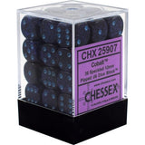 Dark cobalt-blue speckled six-sided dice with light-blue pips are stacked in a clear cube case with a black base. A purple label reads “CHX 25907,” “Cobalt,” and “CHESSEX.”