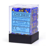 A clear plastic display box with a black base holds blue-and-black marbled D6 dice with gold pips. The blue label reads “CHX 26835” and “36 Black-Blue/gold Gemini™ 12mm d6 Dice Block™.”