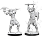 Two unpainted gray miniature female Goliath barbarians stand on black bases: one holds a large axe across her shoulders, while the other raises an axe and carries a shield. Both wear detailed armor and layered clothing.