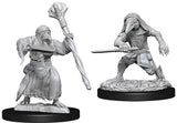 Two unpainted gray Kenku adventurer miniatures on round black bases: one holds a large staff and wears layered robes, while the other crouches with a sword, hood, and textured clothing.