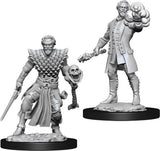 Two gray, unpainted male warlock miniatures stand on round black bases. One wears layered scale-like armor and holds a sword and skull-topped staff; the other wears a long coat and thrusts a swirling magical effect forward.