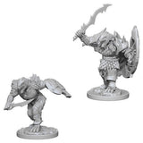 Two gray Dragonborn male fighter miniatures on round bases, shown in different poses: one stands with a raised curved sword and shield, while the other crouches forward with a weapon. Both wear detailed scale armor and helmets.
