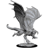 A gray unpainted young black dragon miniature stands on a rocky base, shown in a dynamic pose with its large textured wings spread, tail curled, and claws extended. The sculpt has prominent horns, scales, and ridged details.