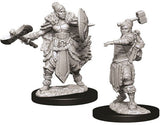 Two unpainted gray female half-orc barbarian miniatures stand on separate black bases: one wears fur-trimmed armor and carries a large axe and shield, while the other raises a hammer and extends one arm.