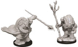 Two gray unpainted Tortle adventurer miniatures stand on round black bases against a white background. One wears a flowing cape and extends a weapon forward; the other holds a tall, branch-like staff.