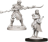 Two detailed, unpainted gray Yuan-Ti fantasy miniatures on display bases against a white background: a larger armored figure holding a long curved blade and a smaller robed figure carrying a stringed instrument.