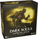 Dark Souls: The Board Game box shown at an angle, with a dark armored warrior against a smoky yellow landscape on the front. Large white lettering reads “DARK SOULS” and “THE BOARD GAME”; the top and left side of the box are also visible.
