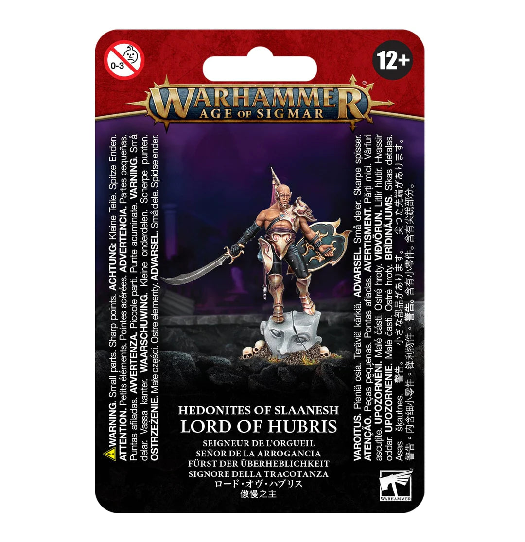 Front of a red, purple and black Warhammer Age of Sigmar package showing a bronze-armored duelist with a curved sword and ornate shield standing on skulls. The card reads “WARHAMMER AGE OF SIGMAR” and “HEDONITES OF SLAANESH LORD OF HUBRIS.”