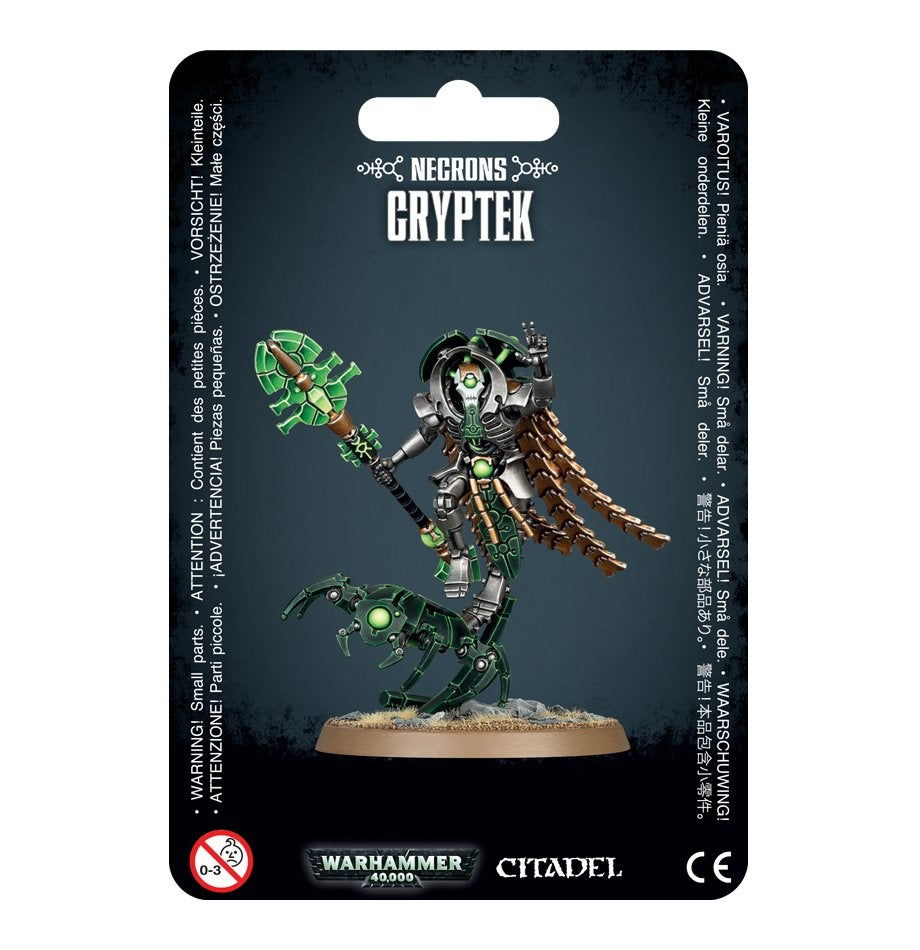 Black hanging package card showing a silver-and-green skeletal Cryptek miniature holding a green staff, with bronze segmented robes and a clawed mechanical mount on a round base. The card reads “NECRONS,” “CRYPTEK,” and “WARHAMMER 40,000.”