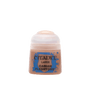 A small peach-toned Citadel paint pot stands upright against a plain green background, with a pale translucent flip-top lid and blue splatter label reading “CITADEL,” “LAYER,” and “CADIAN FLESHTONE.”