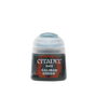 A small, squat Citadel paint pot stands upright with a dark body, red-and-black label, and pale translucent domed cap. The label reads “CITADEL,” “BASE,” and “CALIBAN GREEN” in white lettering.