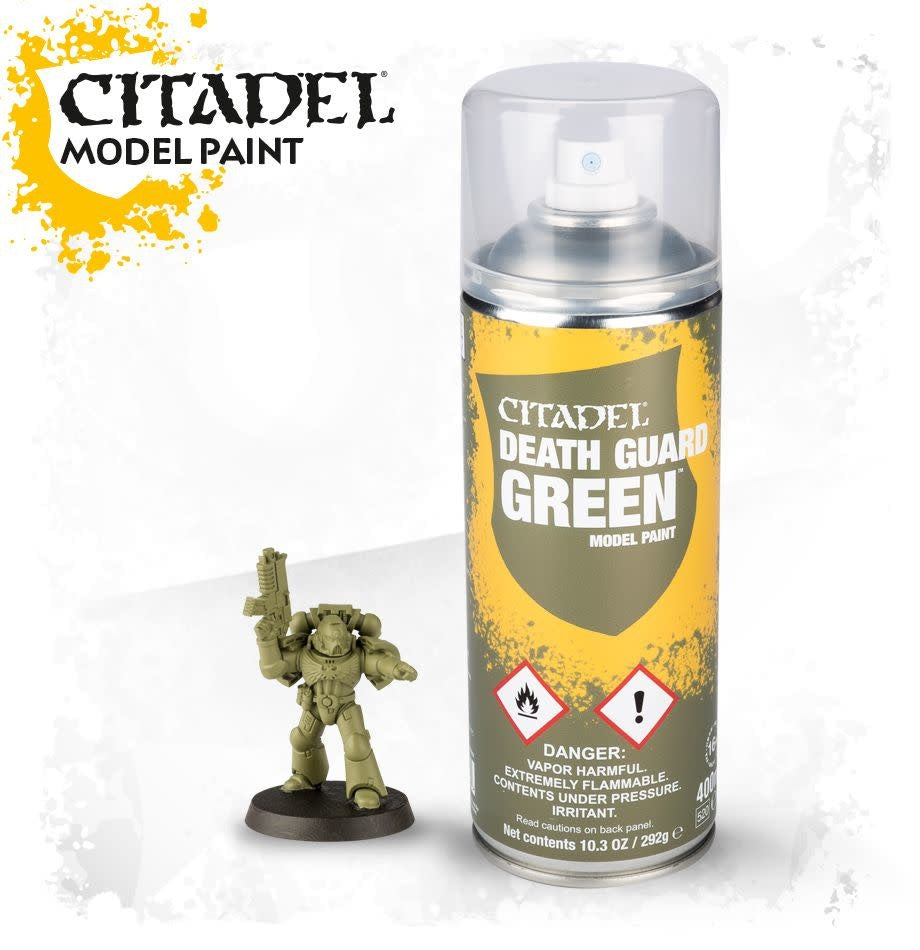 A tall spray can with a clear cap and yellow, gray, and olive-green label stands beside a small olive-green armored miniature holding a raised weapon. The can reads “CITADEL DEATH GUARD GREEN”; “CITADEL MODEL PAINT” appears at upper left.
